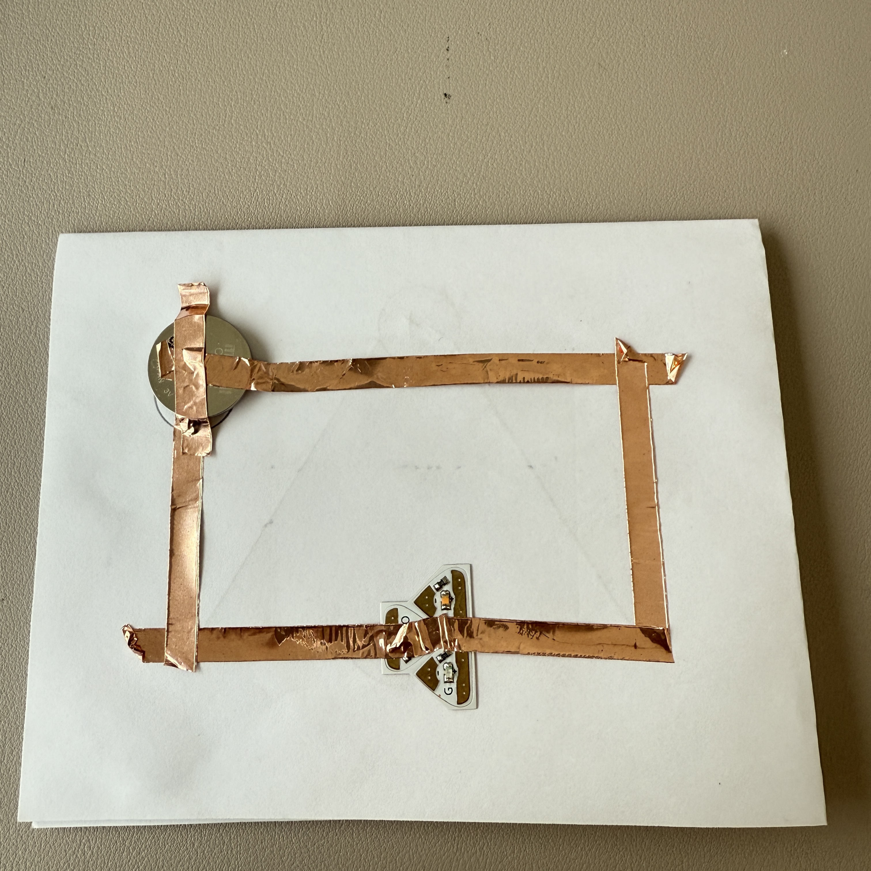 I assembled this rectangular circuit using copper tape, a coin battery, and an LED, ensuring it aligns with my initial diagram.